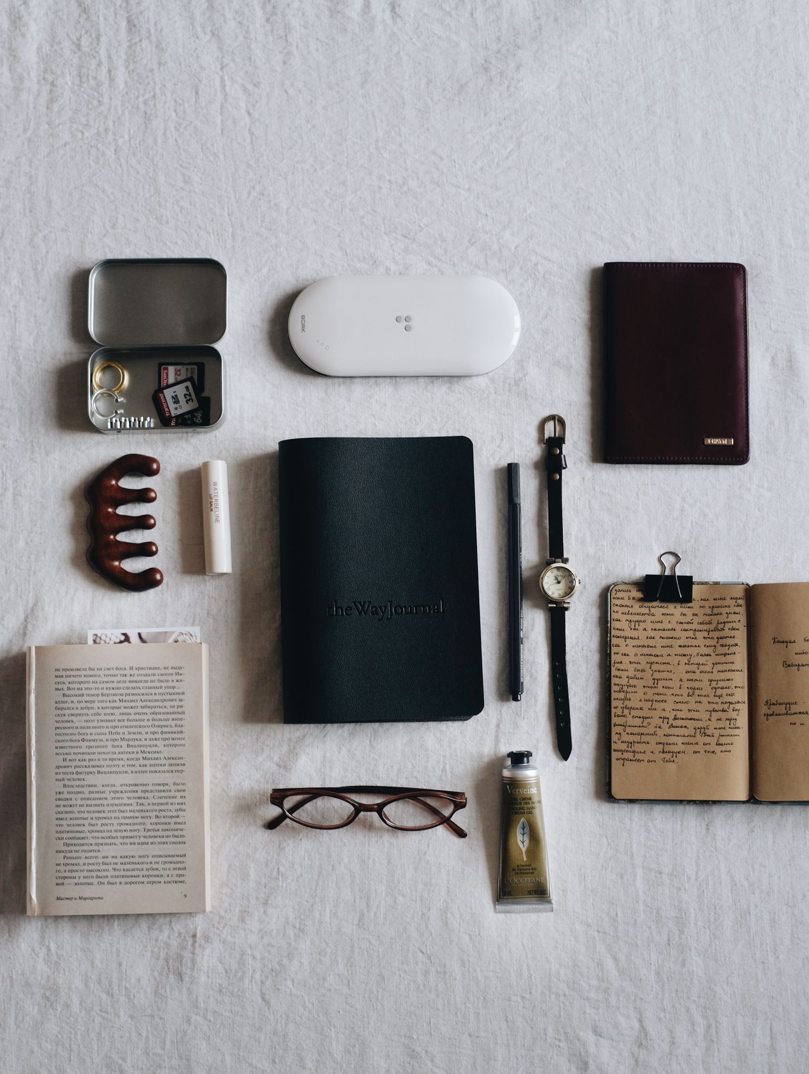 Everyday accessories arranged on a light background